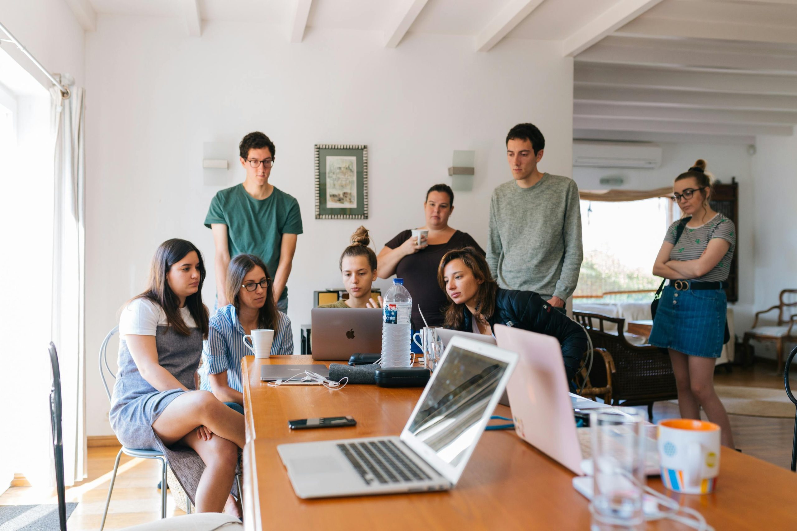 People gathered around a laptop, perhaps designing something from scratch.